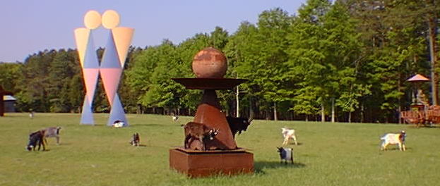 Goats inspecting a sculpture.